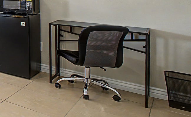 Compact black folding desk in a furnished room rental